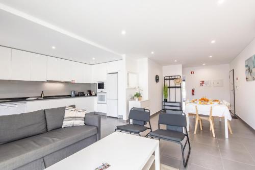 a living room with a couch and a table at Mar T2 - By Smarthomes in São Martinho do Porto