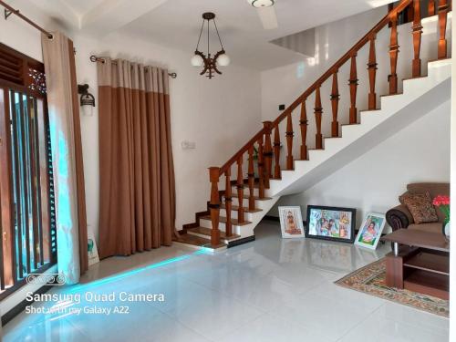 a living room with a staircase in a house at Villa Meghana in Galle