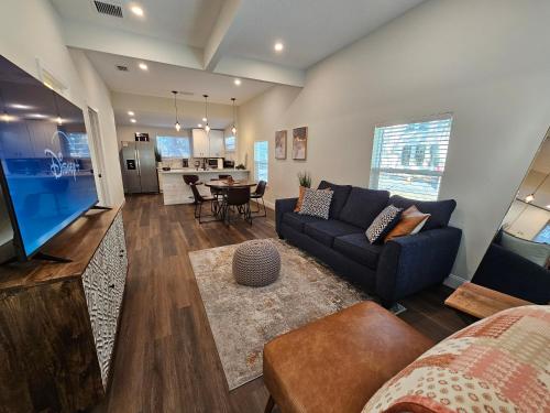a living room with a couch and a table at Steps to Trolley Stop 11 Renovated Home with Free EV Station in St. Augustine