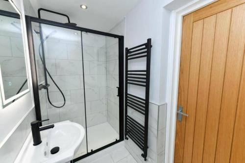 a bathroom with a glass shower and a sink at Brand New City Centre Apartment - Free offsite Parking Available in Nottingham