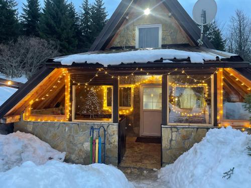 a cabin covered in lights in the snow at Planinska kuca ANDJELA 1 in Mitrovac