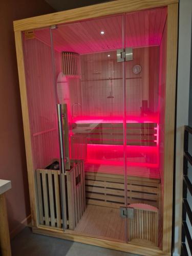 a sauna with pink lighting in a room at MARTEL inLove in Martel