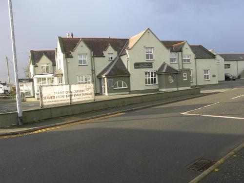 a row of houses on the side of a street at The Valley Hotel, Anglesey in Valley