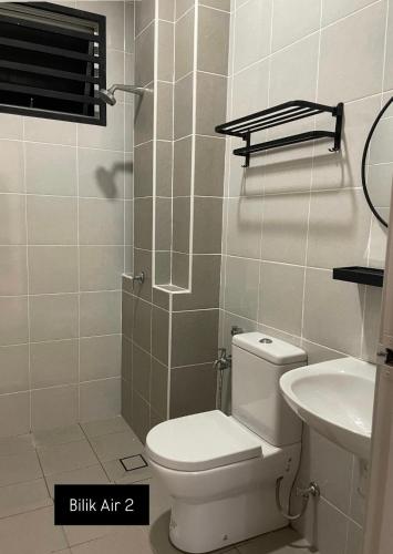 a bathroom with a shower with a toilet and a sink at DNikayla Homestay in Jitra