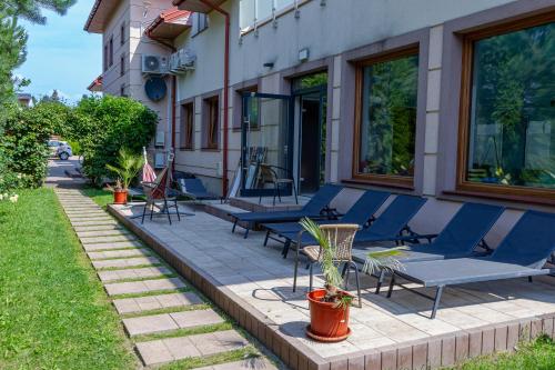 a group of blue chairs sitting outside of a building at Medical Spa Kwiatowa in Łęczyca