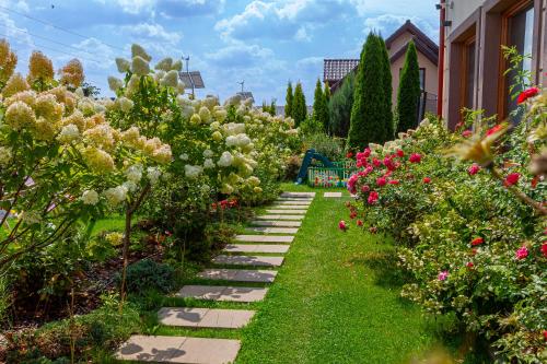 a garden with flowers and a pathway at Medical Spa Kwiatowa in Łęczyca