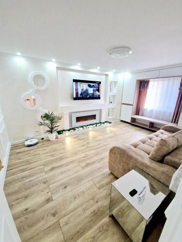 a living room with a couch and a fireplace at Dream ApartHotel in Turda