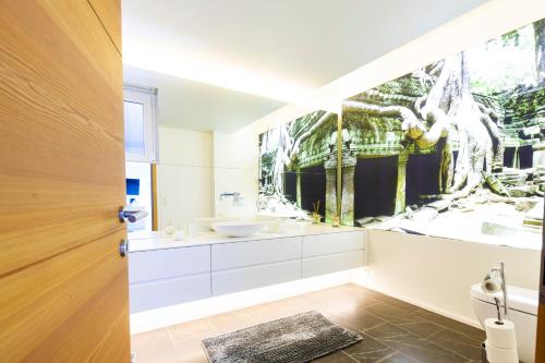 a bathroom with a sink and a mirror at Designferienhaus Altenmarkt Zauchensee in Altenmarkt im Pongau