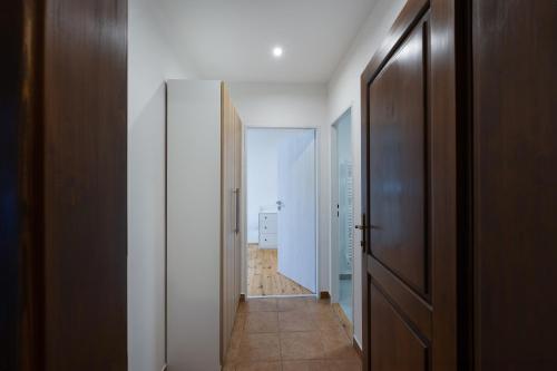 a hallway with an open door to a room at Avama - apartmány Srní in Srní