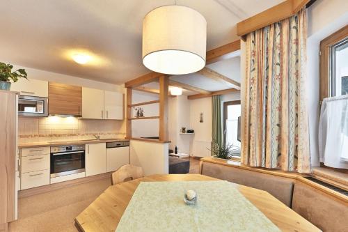 a kitchen and dining room with a wooden table at Haus Oberluggauer in Wald am Arlberg