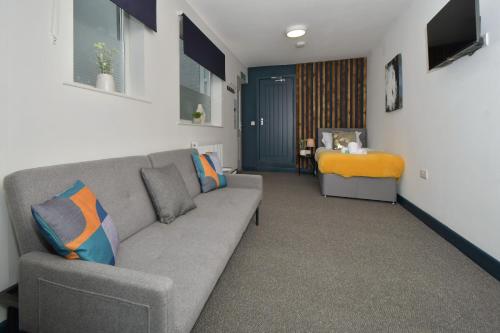 a living room with a couch and a table at Stay at Shobnall Road Rooms and Studios Burton in Burton upon Trent