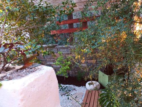 a brick wall with a bench and a fence at Garden house & sea view - Yu Yi in Chavania