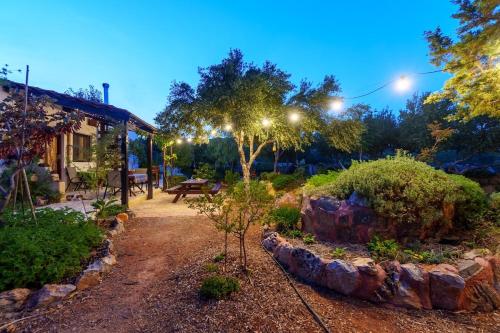 a garden at night with lights on a building at Garden house & sea view - Yu Yi in Chavania