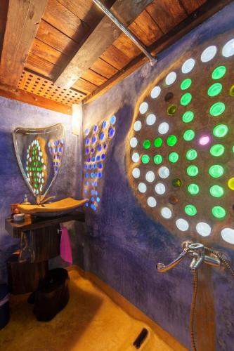 a bathroom with a mirror and a sink with a shower at Garden house & sea view - Yu Yi in Chavania