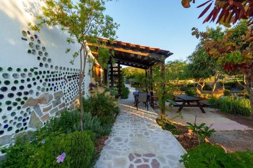 a garden with a wooden pergola and a patio at Garden house & sea view - Yu Yi in Chavania