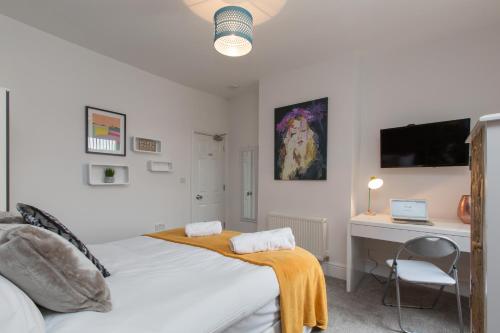 a white bedroom with a bed and a desk at Townhouse PLUS @ 130 West Street Crewe in Crewe