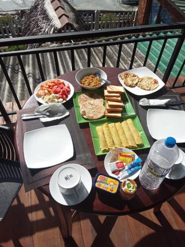 a table full of food on a balcony at Nature Rock Ella in Ella
