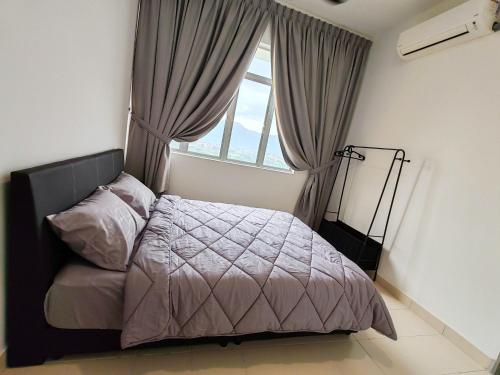 a bedroom with a bed and a large window at BW White Falim Ipoh in Ipoh