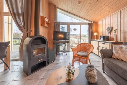 a living room with a wood stove and a couch at Seeschwalbe 23 in Rechlin