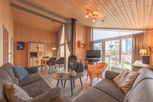 a living room with a couch and a table at Seeschwalbe 23 in Rechlin