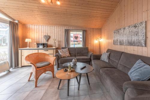 a living room with a couch and a table at Seeschwalbe 23 in Rechlin