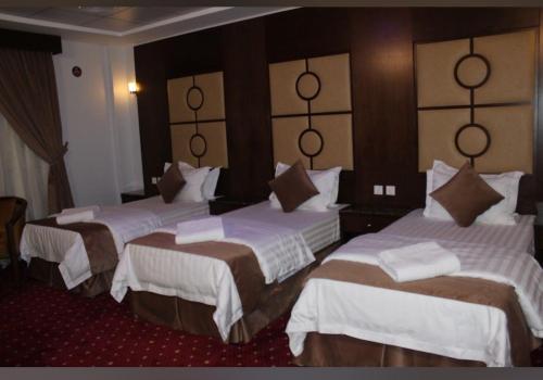 a hotel room with two beds in a room at شقق زهرة الباهية للشقق المخدومة in Najran