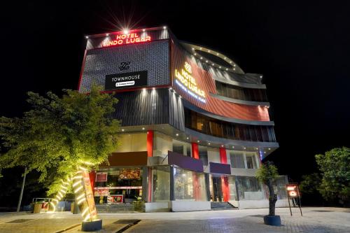 a building with a sign on top of it at night at Super Townhouse Alwar Formerly Hotel Lindo Lugar in Alwar