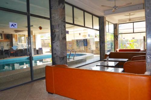 a lobby with a swimming pool and a table and chairs at Residency Apartment and Hotel Guzape Hills Abuja in Abuja