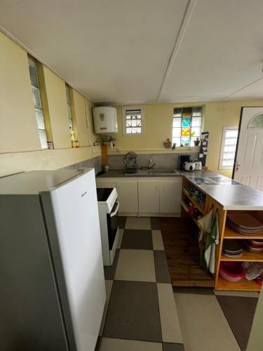 a kitchen with a refrigerator and a counter top at Parenthèse nature in Petite Île