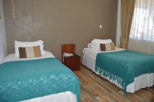 Hotel Duhatao Angolにあるベッド