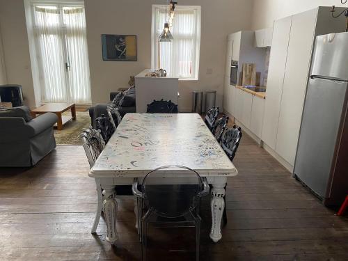 a kitchen with a white table and chairs in a room at Norfolk Chapel hideaway in Briston