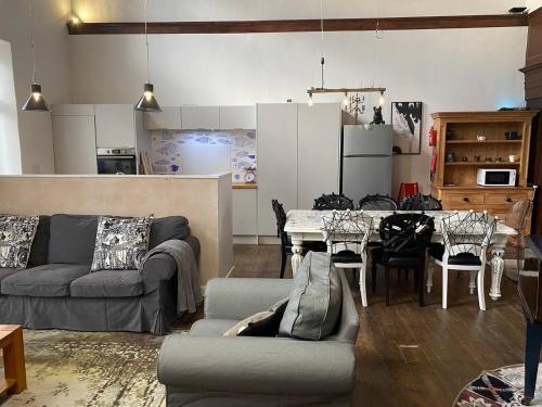 a living room with a couch and a table at Norfolk Chapel hideaway in Briston