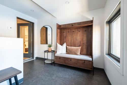 a room with a bed with a mirror and a table at Verbier 6-203 Family Luxury Retreat in Mont-Tremblant