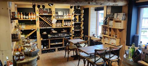 a room filled with tables and bottles of wine at L' Auberge du château in Génos