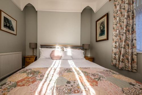 a bedroom with a large bed in a room at Charming character lodge in cemetery grounds in Exeter