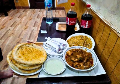 a tray with food and drinks on a table at New Islamabad Hotel in Islamabad