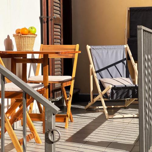 a porch with a table and chairs on a porch at Vista Lago - Lake Como collection in Domaso
