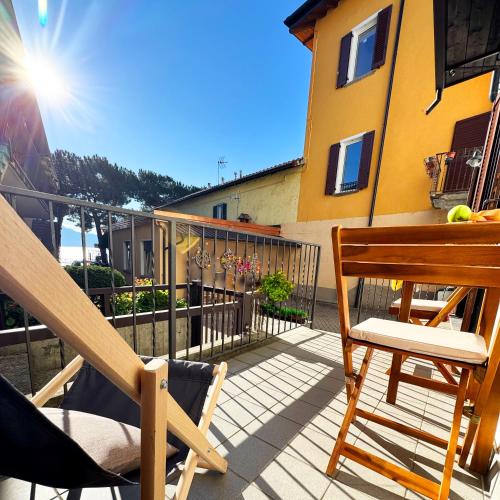 a balcony with a table and chairs on a balcony at Vista Lago - Lake Como collection in Domaso