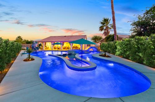 a large pool with blue water in a resort at LAZY RIVER POOL , Water slide, Kids outdoor play area, Arcade games in Coachella