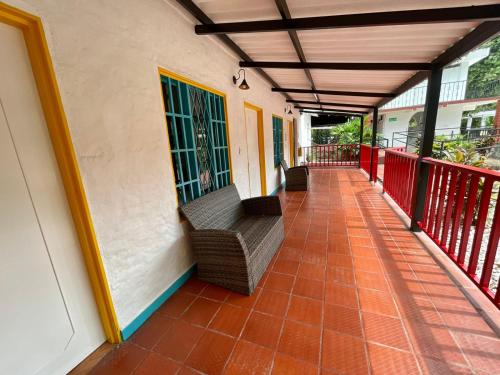 a porch with a bench on a building at Restaurante - Hotel Los Manguitos in Rivera