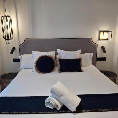 a bedroom with a large bed with towels on it at Citrea Santander in Santander