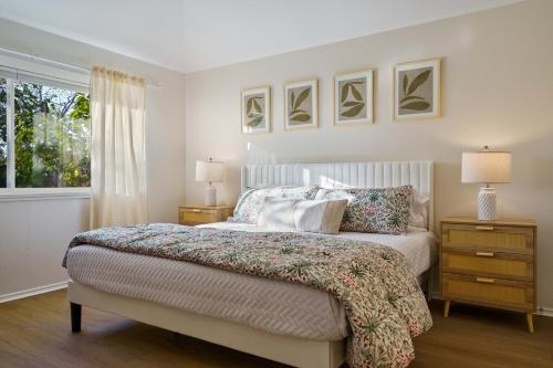 a bedroom with a bed with two night stands and a window at Modern & Cozy Retreat in RoundRock in Round Rock