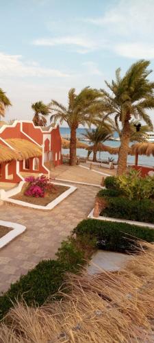 a resort with palm trees and the ocean in the background at Sun Beach Hotel Safaga in Hurghada