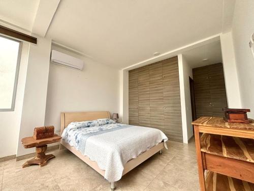 a bedroom with a bed and a large window at Las Casitas en Santa Elena in Santa Elena