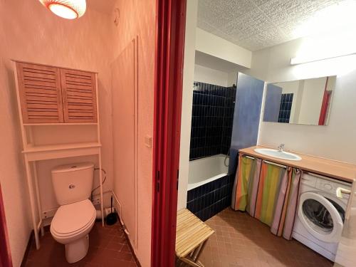 une salle de bain avec toilettes et lavabo et une machine à laver dans l'établissement Sol-y-Days Belles Plages, front de mer avec piscine, à La Grande Motte