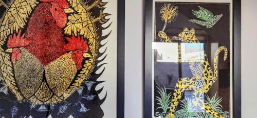 a framed picture of chickens and a giraffe at Chic Townhome Haven rooted Downtown in Albuquerque