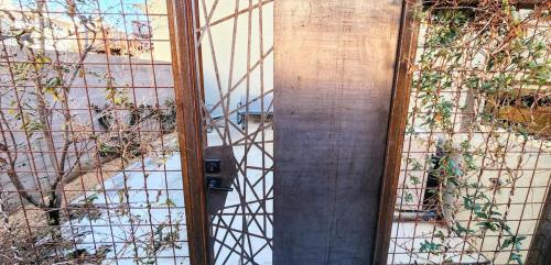 an open door to a building with a fence at Chic Townhome Haven rooted Downtown in Albuquerque