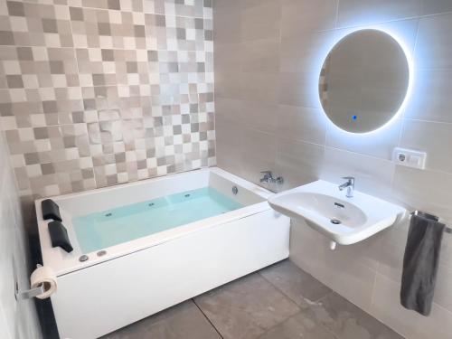 a bathroom with a tub and a sink at ISG Apartments Triana Jacuzzi 1 in Seville