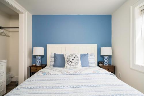 a blue bedroom with a large bed with blue walls at "Hike" at Hills Meaford, Pet Friendly, 2BD Suite in Meaford