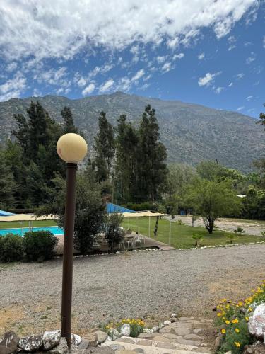 a lamp post with a mountain in the background at Parcela Santa Elena, Cabaña 3 in San José de Maipo